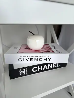 a stack of books with an apple sitting on top at Sisters residence in Kotor