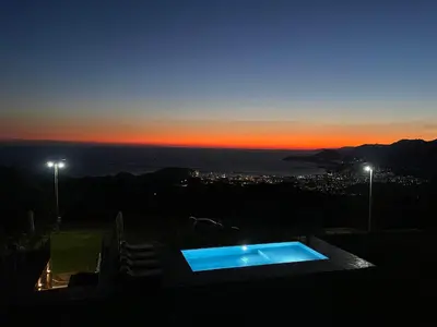 a swimming pool on the roof of a house at sunset at Old House Poda in Rap