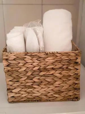 a basket filled with toilet paper on a table at Old House Poda in Rap