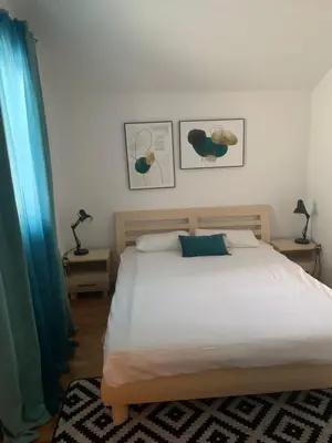 a bedroom with a bed and two tables with lamps at Njaro del mar 16 in Petrovac na Moru