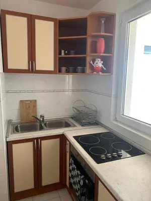 a kitchen with a stove and a sink and a window at Njaro del mar 16 in Petrovac na Moru