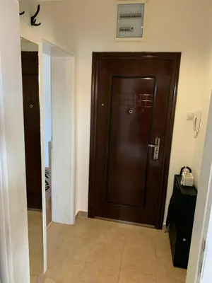 a brown door in a room with a hallway at Njaro del mar 16 in Petrovac na Moru