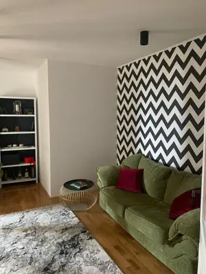 a living room with a green couch and a rug at Njaro del mar 16 in Petrovac na Moru