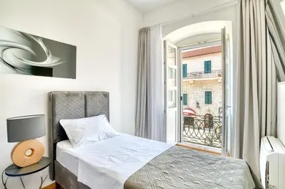 a bedroom with a bed and a window at Luxury Main Square apartment by MN Property in Kotor