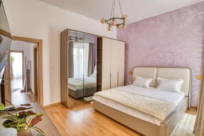 a bedroom with a bed and a mirror at Luxury Main Square apartment by MN Property in Kotor
