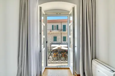an open door to a balcony with a view of a building at Luxury Main Square apartment by MN Property in Kotor
