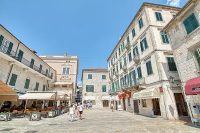 a group of people walking down a street at Luxury Main Square apartment by MN Property in Kotor