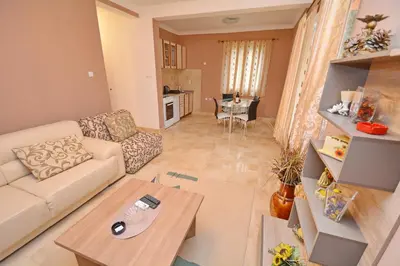 a living room with a couch and a table at Marinero Apartments in Kotor