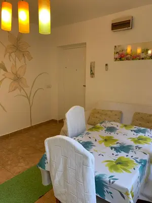 a bedroom with a bed and a chair in it at Njaro del mar 3 in Petrovac na Moru