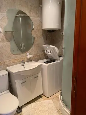 a bathroom with a toilet and a sink and a mirror at Njaro del mar 3 in Petrovac na Moru