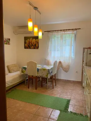 a living room with a table and a couch at Njaro del mar 3 in Petrovac na Moru