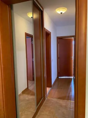a hallway with two mirrors and a hallway with doors at Njaro del mar 3 in Petrovac na Moru