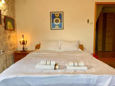 a bedroom with a bed with two towels on it at Charming rooftop view in Kotor