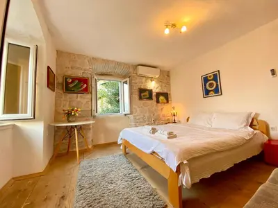 a bedroom with a large bed in a room at Charming rooftop view in Kotor