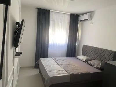 a small bedroom with a bed and a window at Central Terminal Podgorica in Podgorica