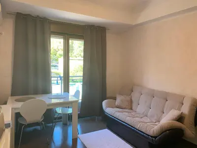 a living room with a couch and a table at Njaro del mar 1 in Petrovac na Moru