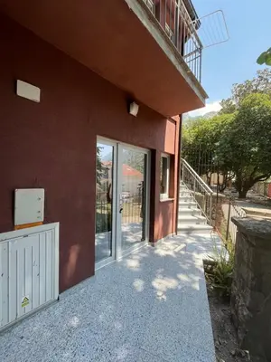 a glass door of a building with a walkway at M&M Apartments in Kotor