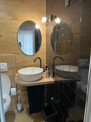 a bathroom with a sink and a mirror at M&M Apartments in Kotor