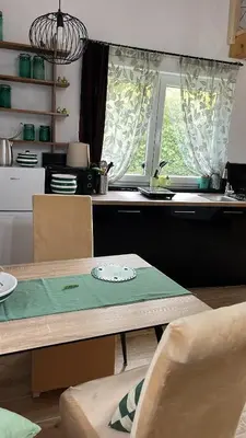 a kitchen with a table with chairs and a window at M&M Apartments in Kotor