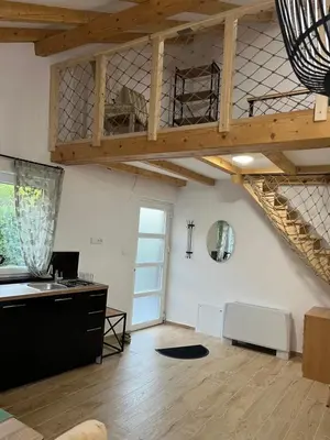 an attic room with a desk and a wooden ceiling at M&M Apartments in Kotor