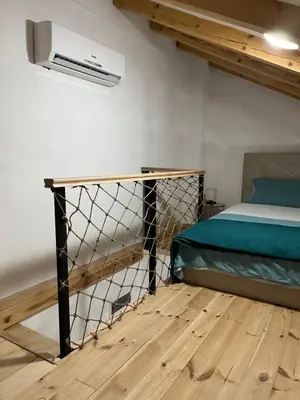 a bedroom with a bed and a fan at M&M Apartments in Kotor
