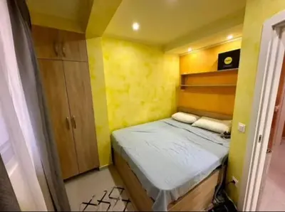 a small room with a bed and a yellow wall at Šušanj Bar in Bar, Susanj