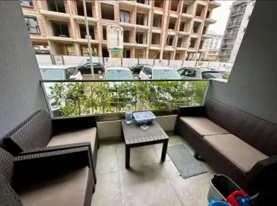 a balcony with two couches and a table in a building at Šušanj Bar in Bar, Susanj