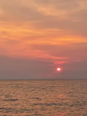 a sunset over the ocean with the sun in the sky at Šušanj Bar in Bar, Susanj