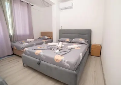 a bedroom with two beds with towels on them at Rine Apartments in Ulcinj