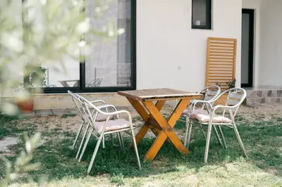 a wooden table and four chairs sitting around a table at Rine Apartments in Ulcinj