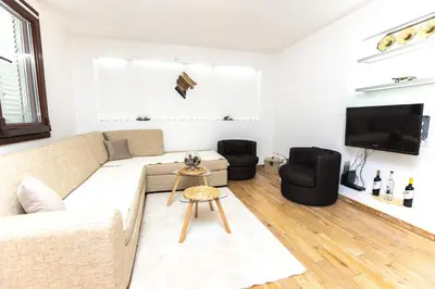 a living room with a couch and a tv at Vukotic in Budva
