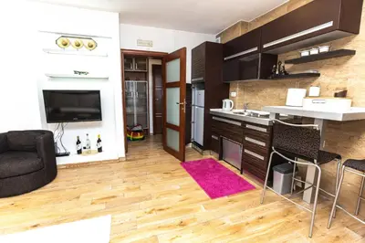 a kitchen and living room with a couch and a table at Vukotic in Budva