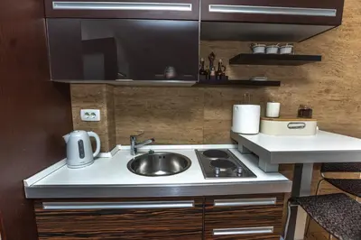 a small kitchen with a sink and a stove at Vukotic in Budva