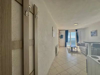 a hallway leading to a living room with a view of the ocean at Calma Vista Apartments by Vila Vanja in Budva