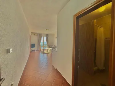 a hallway with a door leading to a room with a kitchen at Calma Vista Apartments by Vila Vanja in Budva