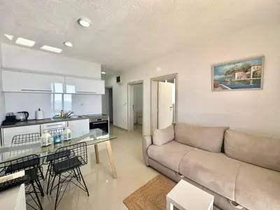 a living room with a couch and a table at Calma Vista Apartments by Vila Vanja in Budva