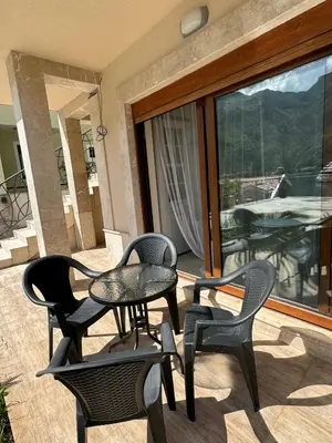 a patio with a table and chairs on a balcony at Apartments Sofia in Kotor