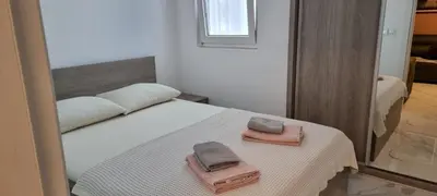 a bedroom with a bed with two towels on it at Apartman Kika in Sutomore