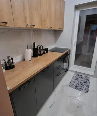a kitchen with a wooden counter top and a sink at Apartman Kika in Sutomore