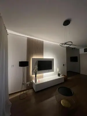 a living room with a flat screen tv on the wall at Lucky in Babalonija