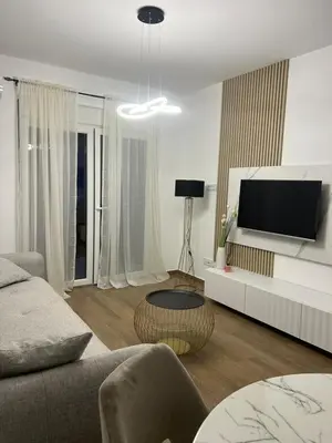a living room with a couch and a tv at Lucky in Babalonija