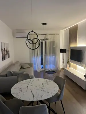 a living room with a table and a couch at Lucky in Babalonija
