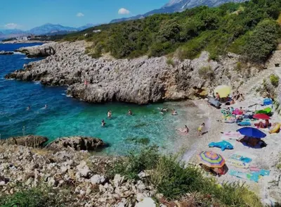 a group of people in the water at a beach at Utjeha Montenegro in Masline