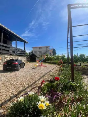 a car parked in front of a house with flowers at Utjeha Montenegro in Masline