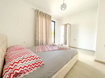 a bedroom with a bed and a window at You GO in Velika Plaža