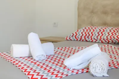 two rolls of toilet paper on a bed at You GO in Velika Plaža