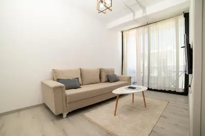 a living room with a couch and a table at You GO in Velika Plaža