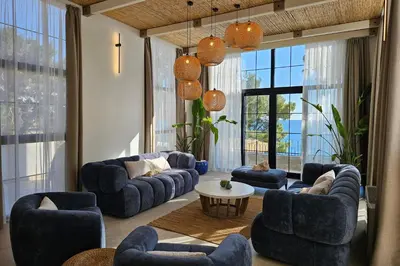a living room with blue couches and a table at SeiSensi Luxury Beach Villa in Gornji Sušanj