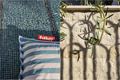 a pillow sitting next to a wall next to a pool at SeiSensi Luxury Beach Villa in Gornji Sušanj