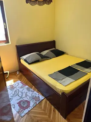 a bed in a small room with aedes at Sea View Budva in Komoševina